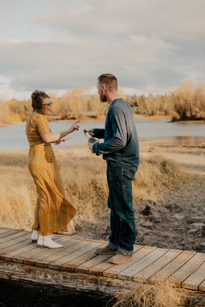 engaged couple drinking champagne