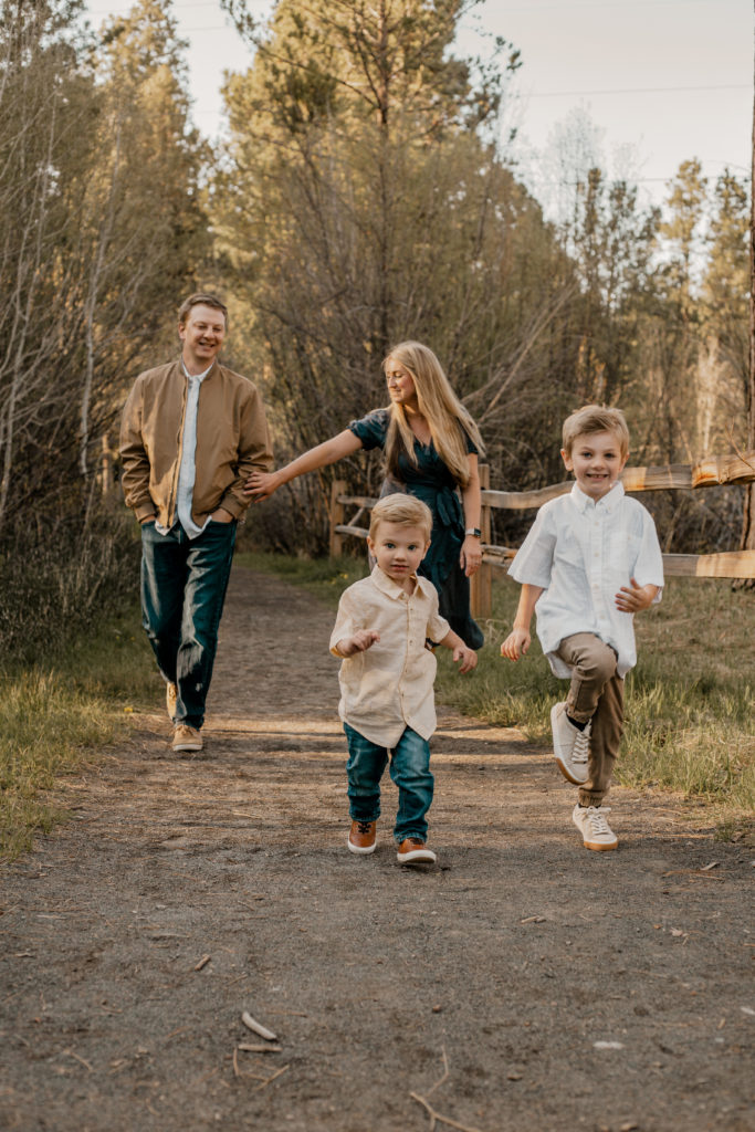 family photography session at shevlin park in bend oregon, family walking down a path smiling